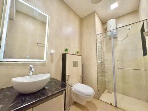 a bathroom with a sink and a toilet and a shower at 3BHK Elegant Duplex Villa with Pool Access in Assagao +23 photos