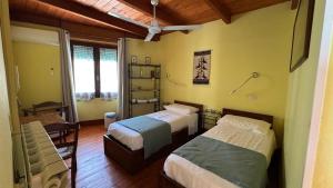 a room with two beds in a room at B&B Muggianeddu in Tonara