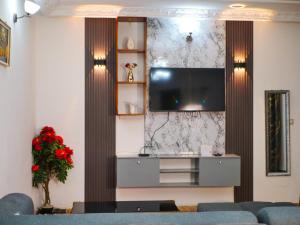 a living room with a couch and a tv at Maridel Home in Yaoundé +7 photos