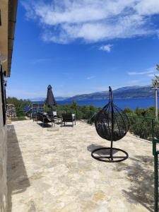 a basket on a patio with a view of the water at Secluded Holiday home HERITAGE in Postira