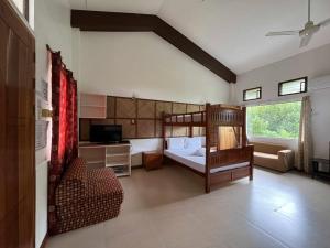 a bedroom with a bunk bed and a living room at Nickles Park Resort in Panglao Island +41 photos