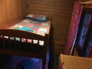 a bedroom with a bunk bed in a cabin at Rowantree View in Roybridge