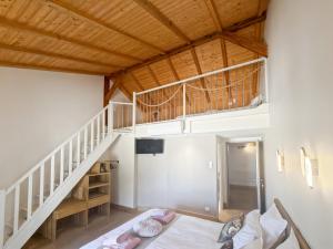 a room with a bed and a staircase at DOMAINE DE LA PORTE in Agonac