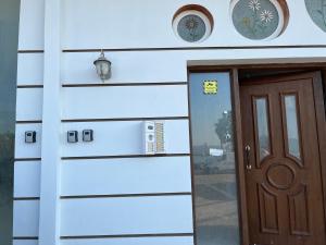 a house with a door and a sign on it at Thalassa View VB2 in Khalkoútsion