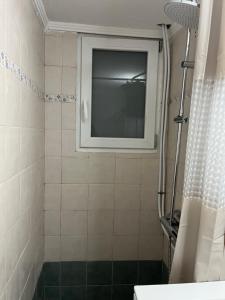 a bathroom with a window and a shower at Thalassa View VB2 in Khalkoútsion