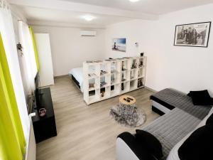 a living room with a couch and a bed in a room at Apartma B & O in Idrija