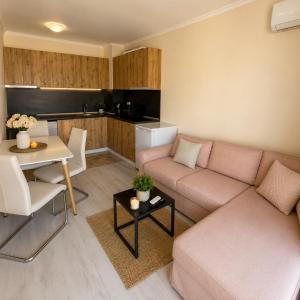 a living room with a couch and a table at Bratanov Sveti Vlas Apartments in Sveti Vlas
