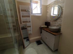 a bathroom with a sink and a mirror at Reve azur plage en duplex coeur de village in Le Pradet +12 photos