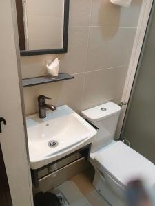 a bathroom with a sink and a toilet at Bonds Hotel in Nairobi