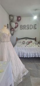 a room with a bed with balloons and a sign at Το Κονάτζι in Statos and Ayios Photios