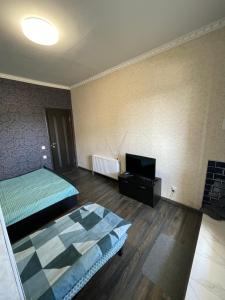 a room with two beds and a flat screen tv at Отель Переулок средний 16 in Kropyvnytskyi