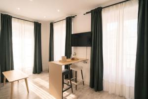 a room with a desk and a table in front of windows at InsideHome Ciudad del Cine in Valladolid