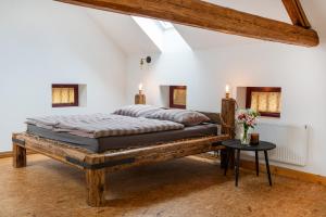 a bedroom with a large bed and a table at statek P22 in Semněvice