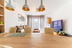 a living room with a large wooden table and a couch at Le Cocon Dracénois in Draguignan