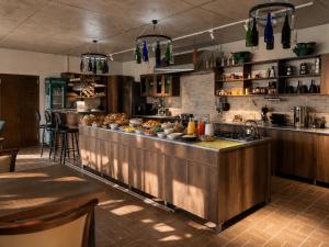 a kitchen with a counter with food on it at Pesvebi Design Hotel and Cellar in Borjomi