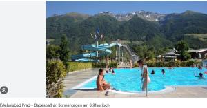 a group of people in a swimming pool at a resort at STILFSER HÜTTL Ein ganzes Ferienhaus für euch in SÜDTIROL in Alleinlage mit Ortlerblick euer Refugium mit privatem Gartenbereich für gemeinsame Zeit zu zweit mit Familie und Freunden und Hund im Nationalpark Stilfserjoch WINTER Skigebiet in d Nähe SULDEN in Stelvio