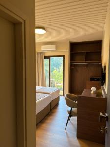 una camera da letto con un letto, una scrivania e una sedia di Pine Inn a Spilia