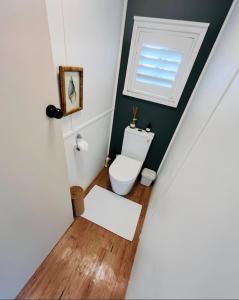 a bathroom with a toilet and a window at Marley's at Boma in Bomaderry +19 photos