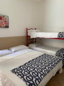 a room with three bunk beds in a room at Cardiff Hotel in Marina di Camerota