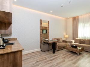 a living room with a couch and a table at Marmara Boutique in Medina