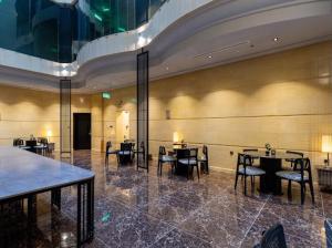 a dining room with tables and chairs in a building at Marmara Boutique in Medina