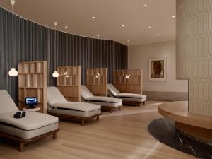 a waiting room with a bunch of chairs and tables at Hotel Kämp in Helsinki