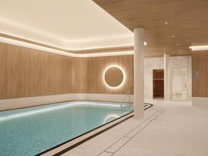 a large swimming pool in a room with a ceiling at Hotel Kämp in Helsinki
