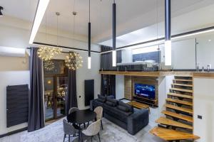 a living room with a couch and a table at Boulevard Residence Suite, 3 in Tashkent