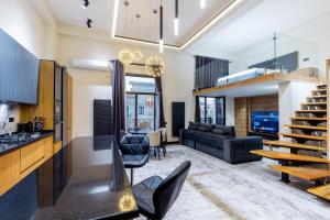 a living room with a couch and a table at Boulevard Residence Suite, 3 in Tashkent