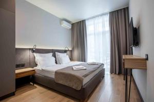 a hotel room with a bed and a television at Apartel Shayan in Shaian