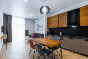 a kitchen and dining room with a table and chairs at Apartel Shayan in Shaian