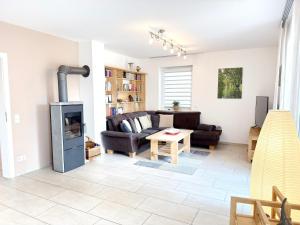 a living room with a couch and a fireplace at Spreedeich in Werben