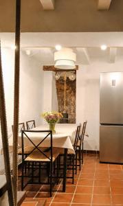 a dining room with a table and a refrigerator at Casita de Mar in Tossa de Mar +27 photos