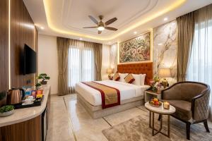 a hotel room with a bed and a chair at Hotel Skynex - Near Delhi Aerocity in New Delhi