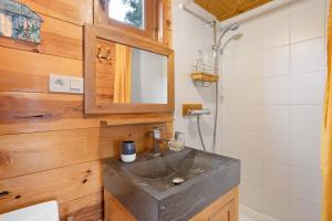 a bathroom with a sink and a mirror at Chalet Studio Athome in Bouhet +19 photos
