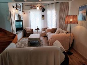 a living room with two beds and a couch at Reve azur plage en duplex coeur de village in Le Pradet
