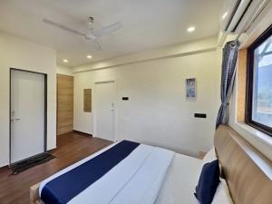 a bedroom with a large bed and a window at II EMPYREAN STAYS II WHITE PANTHER VILLA II 3BHK II AC II PRIVATE POOL ll in Lonavala +21 photos