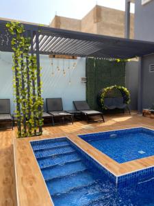 a swimming pool in the middle of a patio at Studio moderne in Saly Portudal