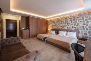 a hotel room with two beds and a couch at Agape Rose in Tivat +69 photos