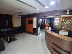 a lobby with a reception desk in a building at Hotel 9 square in Shamshabad