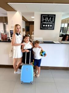 a woman and two children standing in a store with a suitcase at Hotel Spa Mirador in Jorquera +74 photos