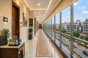 a hallway of a building with a view of a city at Hotel Skynex - Near Delhi Aerocity in New Delhi