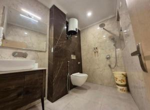 a bathroom with a shower and a toilet and a sink at Hotel Skynex - Near Delhi Aerocity in New Delhi