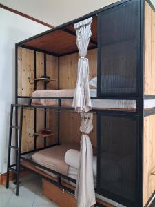 a bunk bed with two bunk beds in a room at Nglinteg Hostel in Yogyakarta