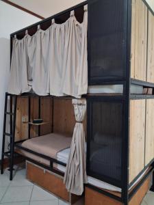 a couple of bunk beds in a room at Nglinteg Hostel in Yogyakarta +2 photos