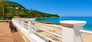 a white fence on a beach near the water at Perla Marina Tropea in Parghelia