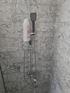 a shower with a blow dryer in a bathroom at Krikonis Apartments Leptokarya in Leptokarya