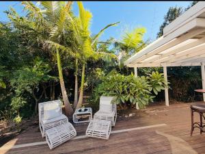 a group of chairs sitting on a wooden deck at Marley's at Boma in Bomaderry