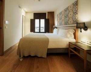a hotel room with a large bed and a window at Hotel Estepona Plaza in Estepona