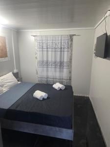 a bedroom with a bed with two towels on it at Krikonis Apartments Leptokarya in Leptokarya +7 photos